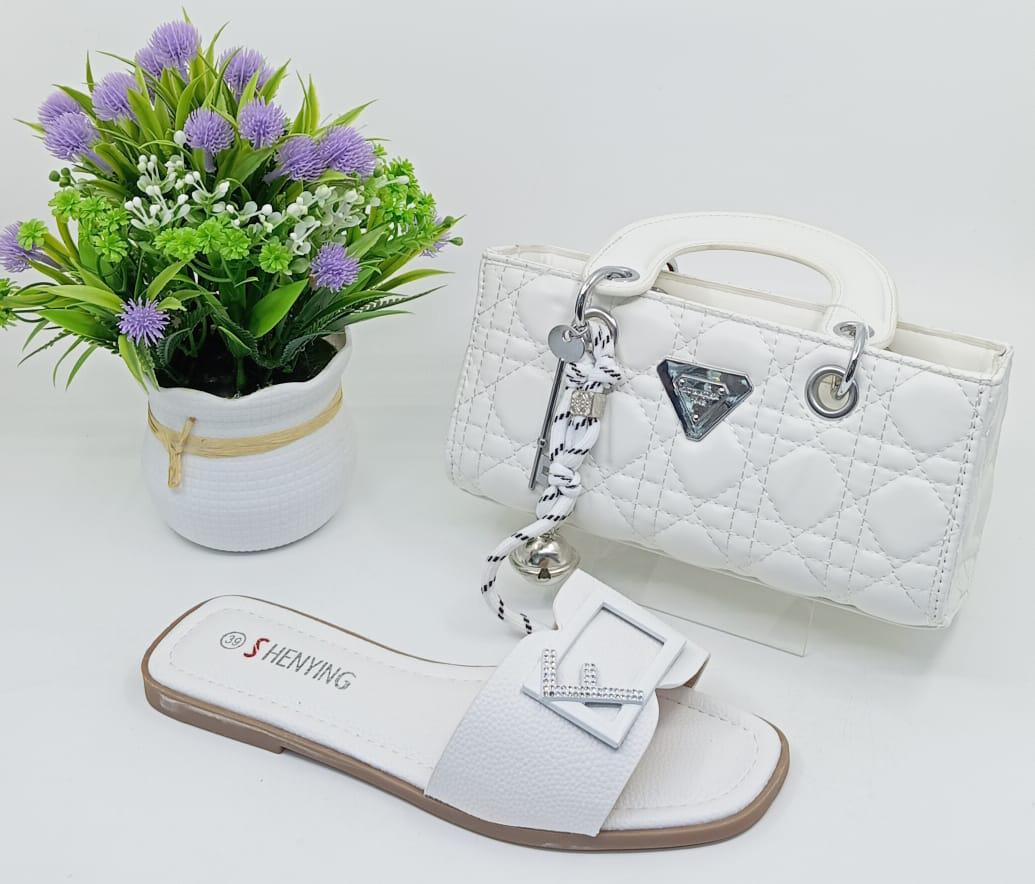 Stylish Matching Set – Includes a trendy shoulder bag and elegant slip-on sandals in coordinating silver tones.